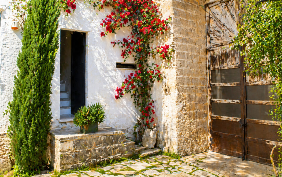 Corte d’ingresso della Dimora di German con portone in legno nel Salento